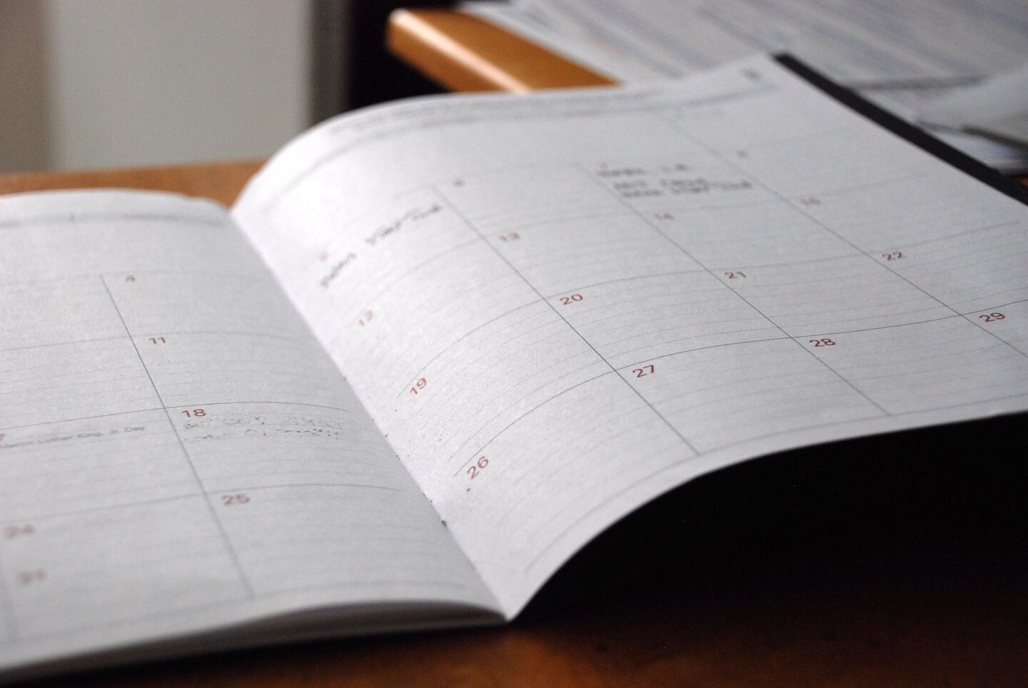 notebook-planner lying on table showing a calendar