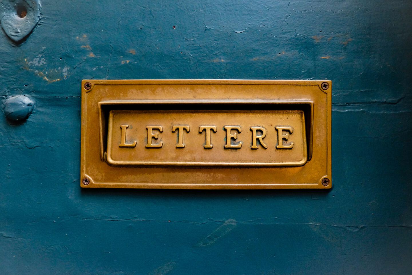 brown signage reading Lettere on teal wall